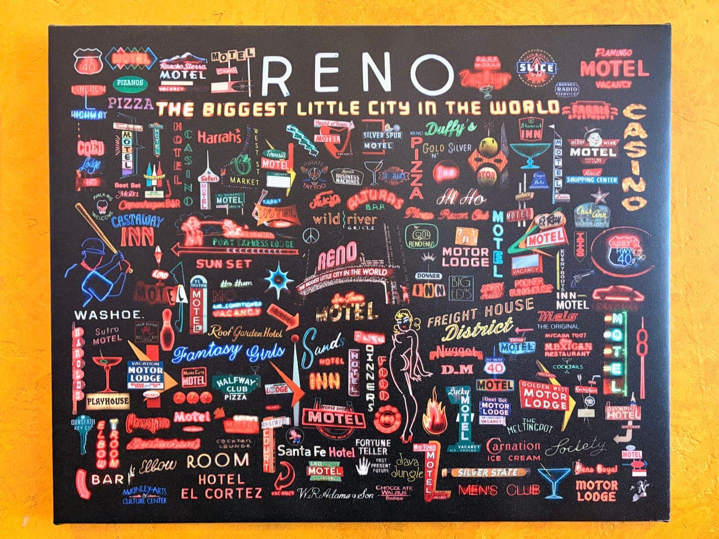 This vibrant canvas, titled 'RENO THE BIGGEST LITTLE CITY IN THE WORLD,' is a nostalgic homage to Reno's iconic neon signs and vintage motels. The artwork is a dense collage of colorful, retro-inspired signage, featuring names like 'Harrah's,' 'El Cortez,' and 'Fantasy Girls,' evoking a lively, old-school Vegas vibe. It captures the essence of a bygone era with its playful illustrations of casinos, motels, and various establishments, all rendered in a charming, illustrative style.